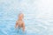 Toddler rejoices and bathes in water. Tourism with small child and recreation on sea. Safe bathing for babies