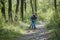 Toddler riding a balance bike along the path in the park