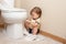 Toddler ripping up toilet paper