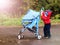 Toddler rolls stroller himself outdoors