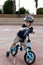 Toddler sitting on his balance bicycle