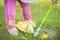 Toddler is sweeping a trash on a green lawn. Selective focus