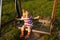 Toddler swinging on the swing in summer