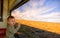 Toddler on a train ride with hands on window