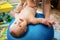 Toddler training with gymnastic ball with mother at home.