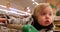 Toddler in warm jacket in supermarket