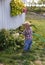 Toddler watering the garden