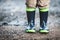 Toddler wearing rubber boots in rainy weather