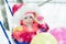 Toddler winter sledding with balloons.