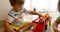 Toddlers sitting on floor and playing toy cars