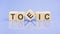 TOEIC - word is written on wooden cubes on a blue background. close-up of wooden elements