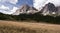 Tofana mountain group with mountain meadow and blue sky with clouds in Dolomites mountains in Italy