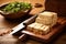 tofu being sliced with a sharp knife on wooden board