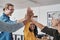 Together we can achieve anything. a group of businesspeople joining hands together for a high five inside an office.