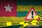 Togo flag and Covid-19 quarantine yellow tape. Coronavirus or 2019-nCov virus
