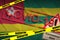 Togo flag and Covid-19 quarantine yellow tape with red stamp. Coronavirus or 2019-nCov virus
