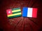 Togolese flag with French flag on a tree stump isolated