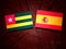 Togolese flag with Spanish flag on a tree stump