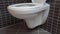 Toilet bowl, lavatory in modern bathroom with black and grey tiles, HD 1080p, upward tilt, open lid