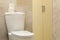 Toilet bowl in modern bathroom in light beige color