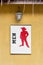 Toilet male signs on wood board with yellow rough cement wall ba