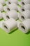 Toilet paper concept on green background. Hygiene and health. Co