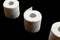 Toilet paper holder. Soft tissue roll isolated on black background. Bathroom hygiene concept