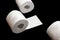 Toilet paper holder. Soft tissue roll isolated on black background. Bathroom hygiene concept