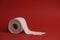 Toilet paper roll on red background. Soft hygienic paper