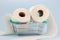 Toilet paper roll in shopping cart on blue background.Concept of hoarding, panic buying toilet paper. Covid-19 pandemic