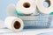 Toilet paper roll in shopping cart on blue background.Concept of hoarding, panic buying toilet paper. Covid-19 pandemic