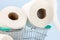 Toilet paper roll in shopping cart on blue background.Concept of hoarding, panic buying toilet paper. Covid-19 pandemic