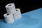 Toilet paper roll. Soft hygienic paper. Black blue background