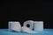 Toilet paper roll. Soft hygienic paper. Black blue background
