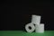 Toilet paper roll. Soft hygienic paper. Black green background