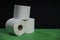 Toilet paper roll. Soft hygienic paper. Black green background