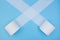 Toilet paper rolls uncoil across diagonal on a blue background. Do not panic. Stay home