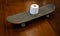 Toilet paper on a skateboard on a wooden table