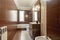 Toilet tiled in shades of brown and cream with matching furniture