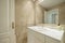 Toilet with white lacquered furniture, granite countertops and walls covered