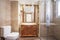 toilet with wooden slatted cabinet, rectangular mirror