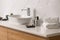 Toiletries and stylish vessel sink on countertop in modern bathroom