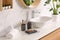 Toiletries and stylish vessel sink on light countertop in bathroom