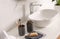 Toiletries and stylish vessel sink on light countertop in bathroom