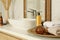 Toiletries and towels on white countertop near mirror