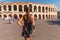 Toirust woman in Verona historical center on square near Arena Verona, Roman amphitheater. Traveler in famous travel destination