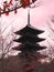 Toji wooden pagoda against soft pink sky and orange leaves.