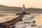 Tokarevsky lighthouse on the Egersheld peninsula in Vladivostok on a winter morning at dawn among ice floes floating in the sea