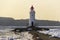 Tokarevsky lighthouse on the southern tip of Vladivostok at dawn, on an early spring morning, among ice floes floating in the sea