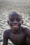 Tokeh Beach, Sierra Leone - January 05, 2014: Portrait of unidentified young African boy smiling at mangrove beach